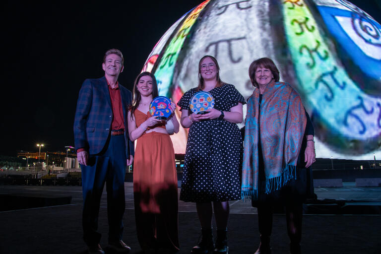 A man and three women stand in front of the MSG Sphere