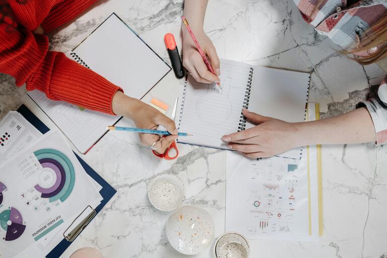 two artists working together drawing an illustration