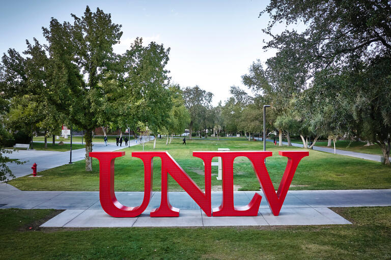 Photo of large letter sculptures on campus grounds. The letters spell: UNLV
