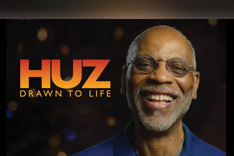 Photo of smiling man with glasses and the words: "Huz: Drawn to Life"