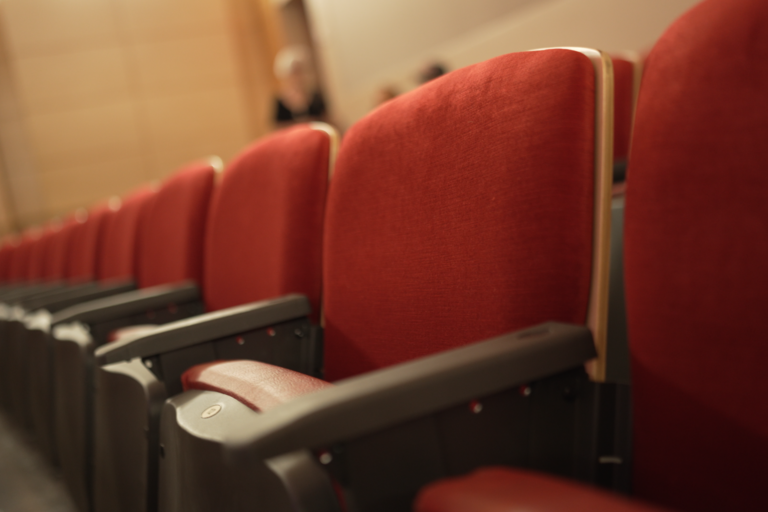 Red seats inside Doc Rando Recital Hall
