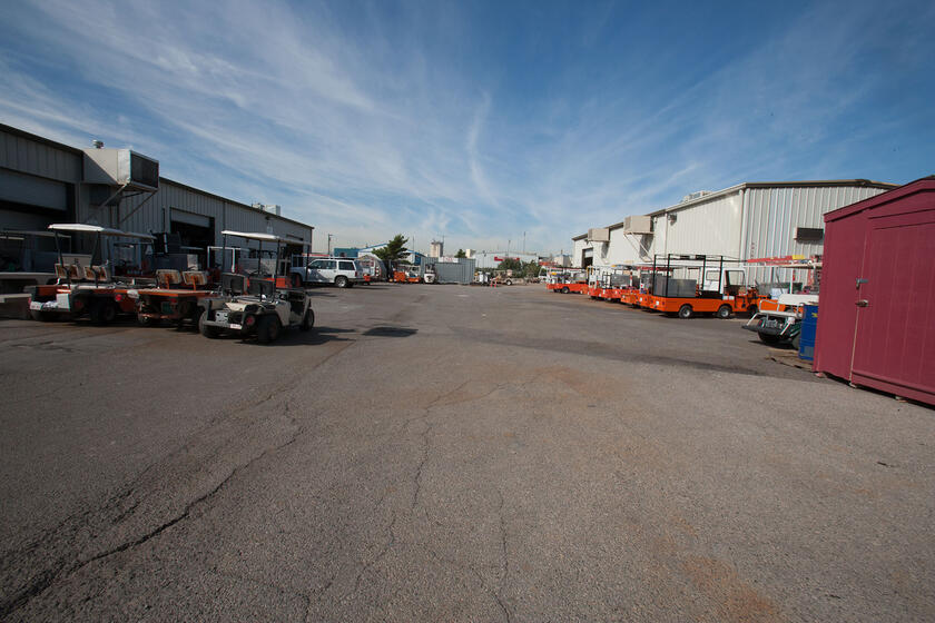 Many golf carts parked outside the Operations and Maintenance complex