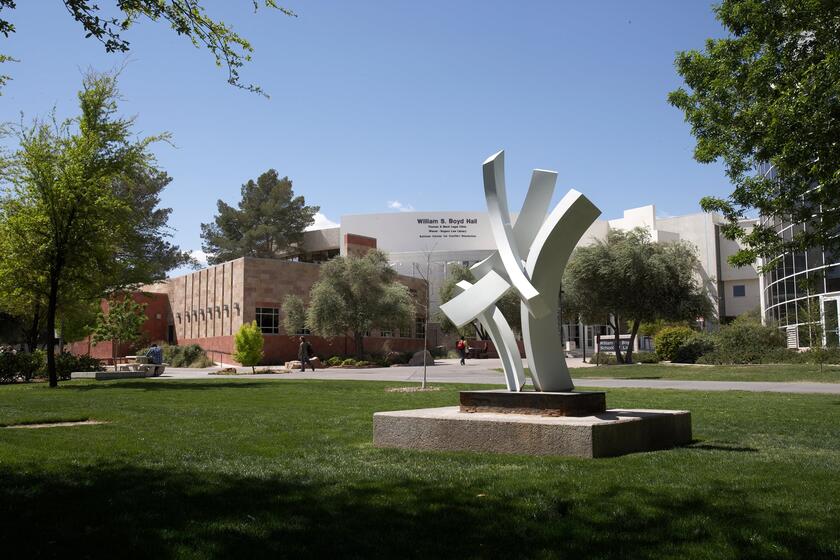 White sculpture stands in grassy area
