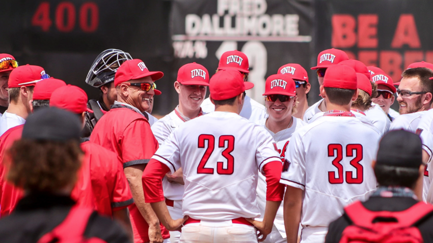 A group of UNLV baseball players gathered in a circle during a baseball game.