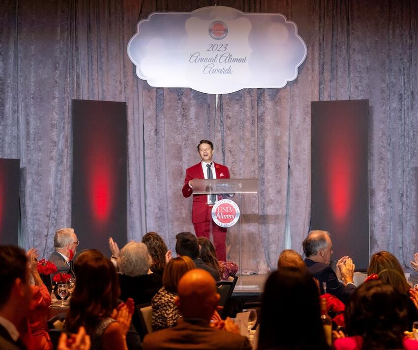 A person at a podium speaking to a crowd
