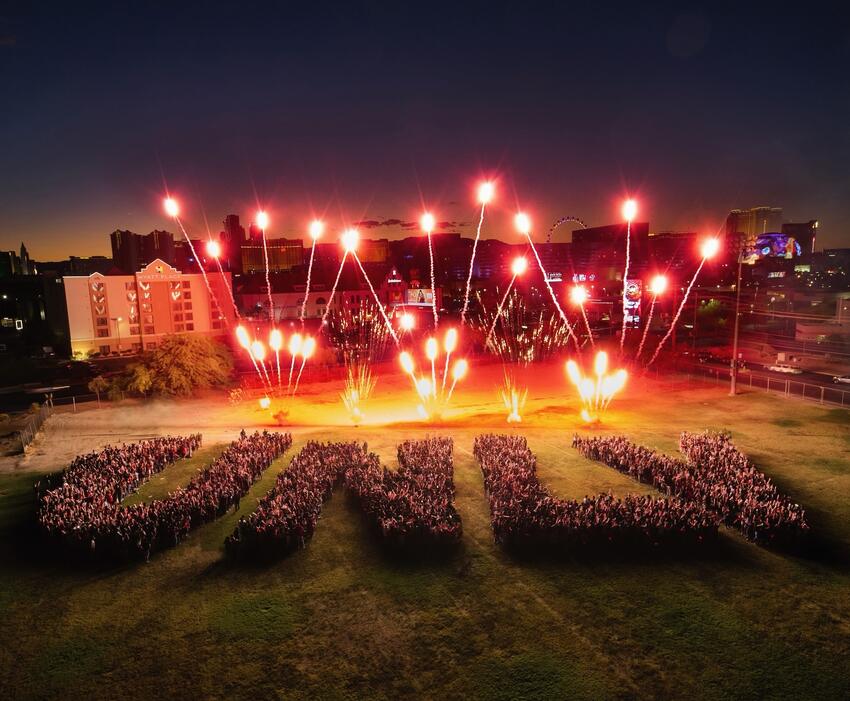 Fireworks being lit up as students form the letters U-N-L-V for UNLV Premier