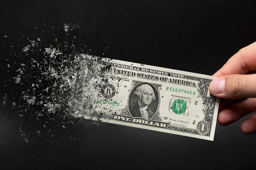 A picture of a crumbling dollar bill