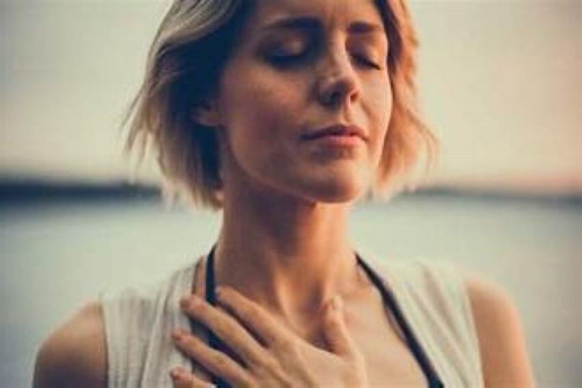 A woman practicing deep breathing