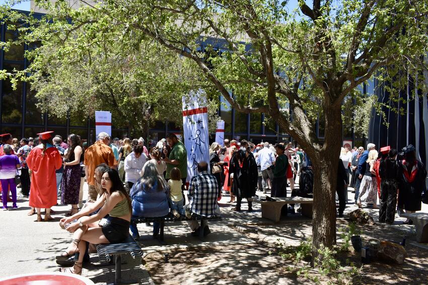 A crowd of fine arts students outdoors at graduation