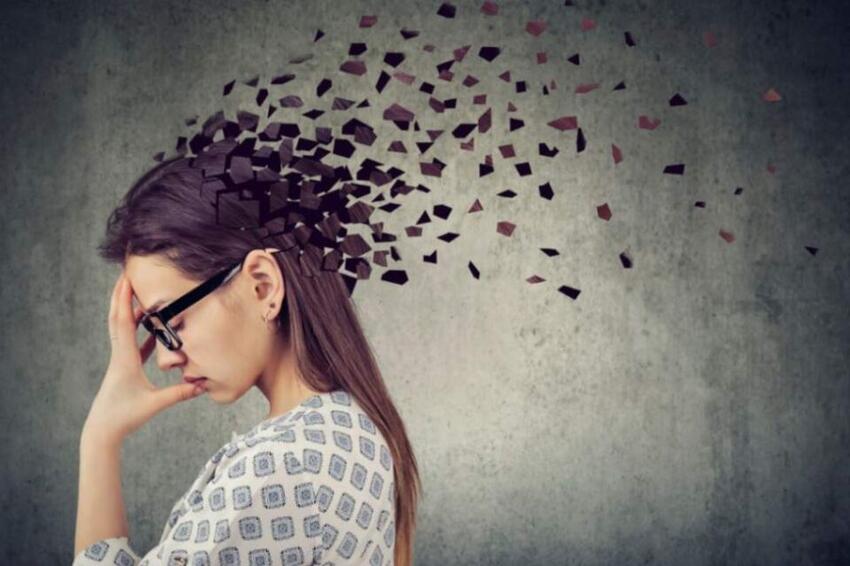 A woman holding her head in her hand