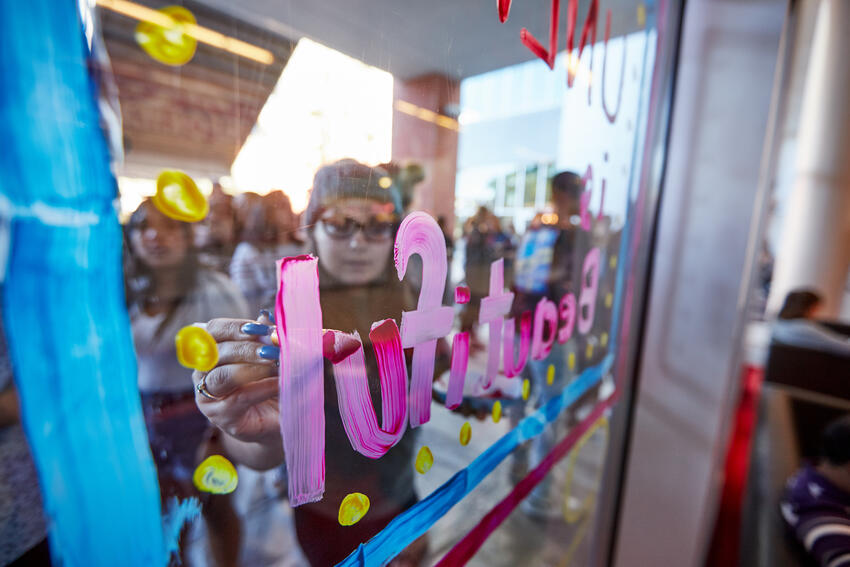 Students painting windows for homecoming