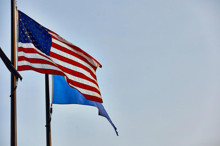 USA and Nevada flags waving in the air