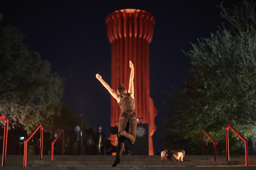 UNLV Flashlight sculpture with dancer jumping in front