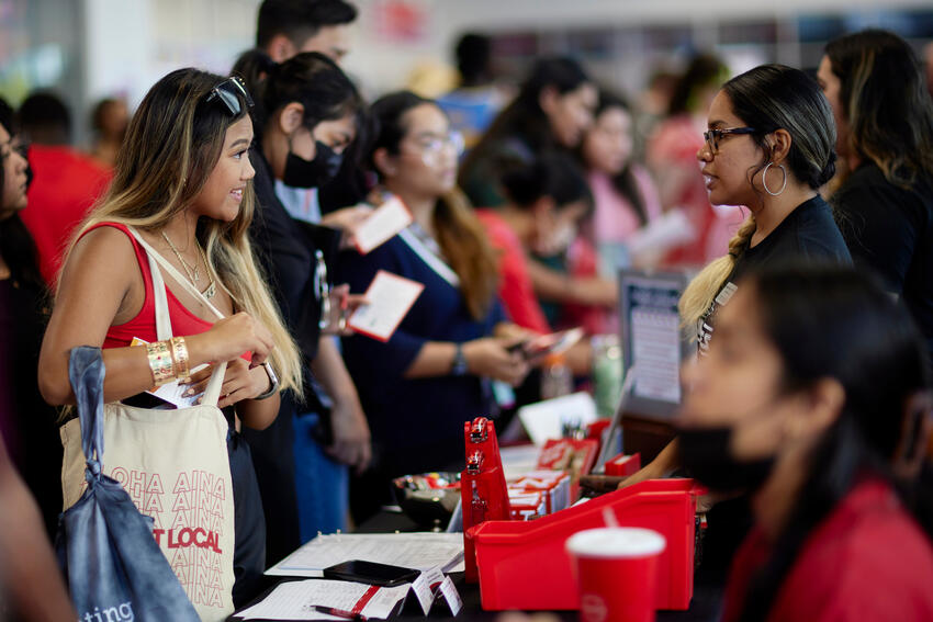 Student speaking to a recruiter at a career fair