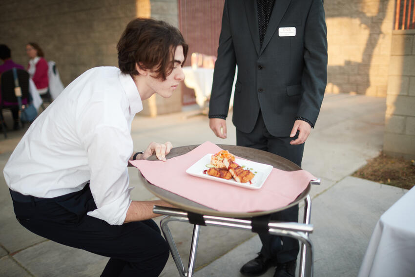 A student serving food