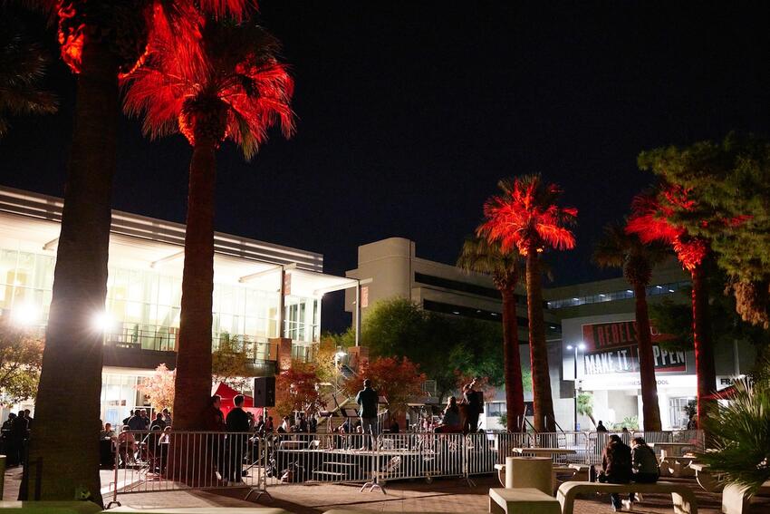 Speaker standing on a stage on Pida Plaza