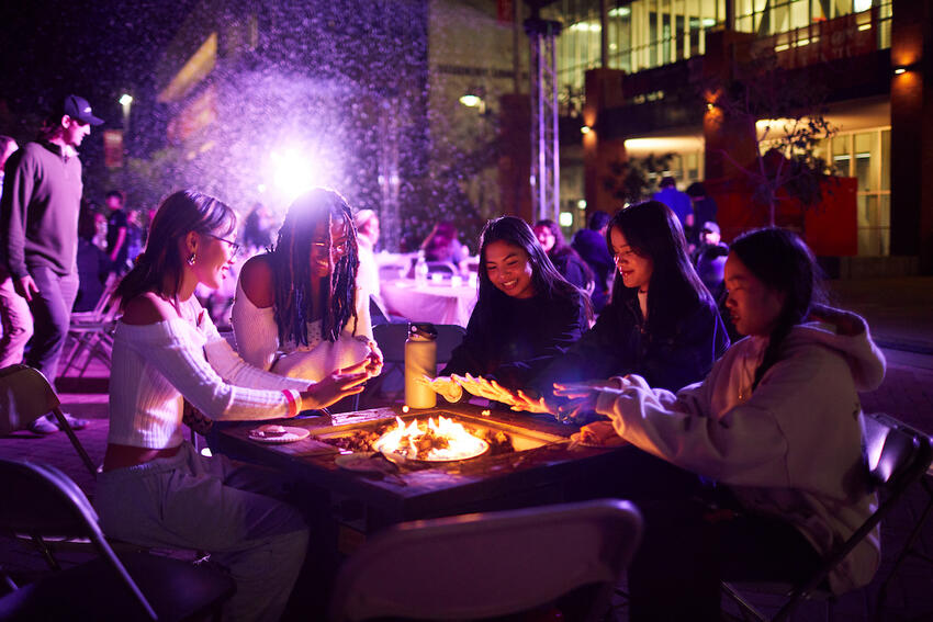 Students gathered around a fire