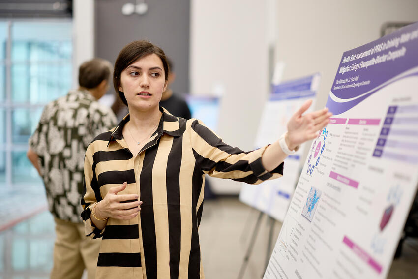 A student presenting a poster