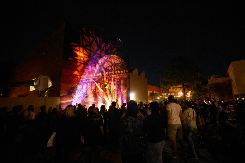 Photo of a UNLV mural illuminated at night