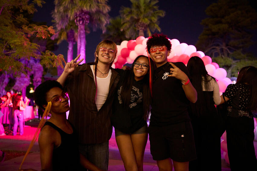 A group of four students posing at late night breakfast