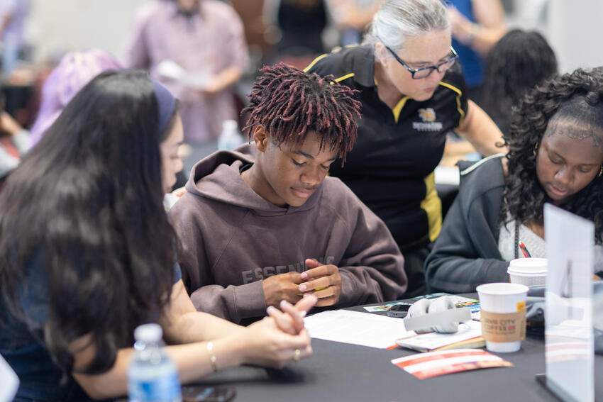 A group of students working at a table together