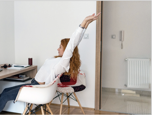 a person stretching at their desk