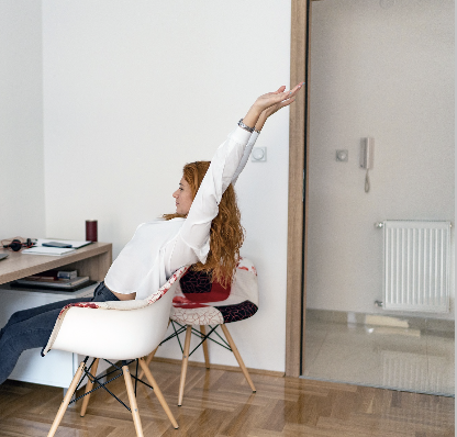 A woman stretching in a chair