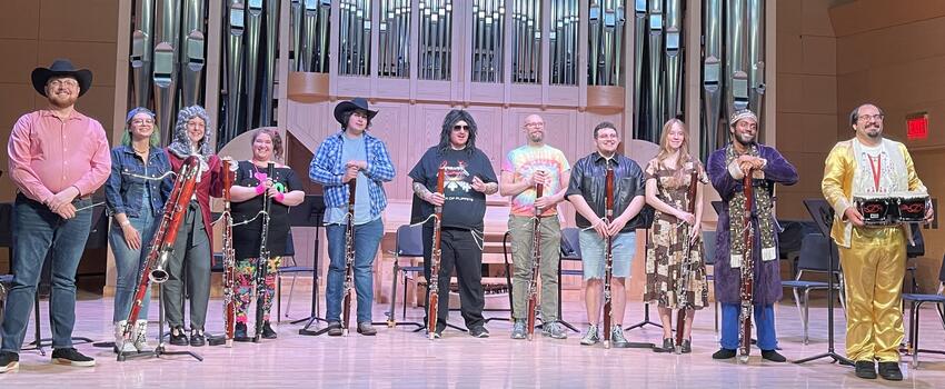 A group of students on stage with their musical instruments