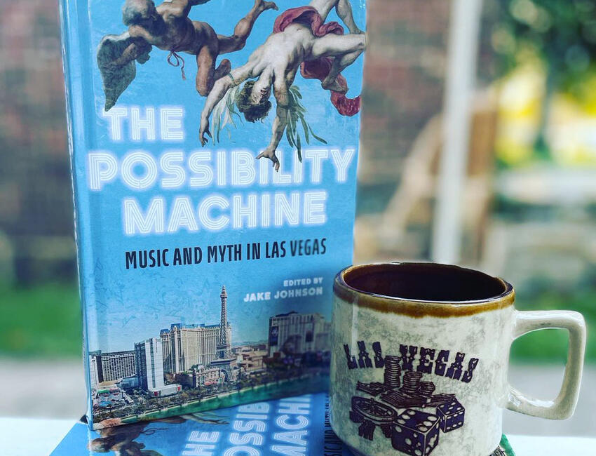 A copy of the book &quot;The Possibility Machine: Music and Myth in Las Vegas,&quot; posed in front of a Las Vegas mug.