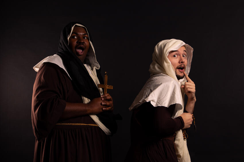 Two actors dressed as nuns with surprised expressions on their face.