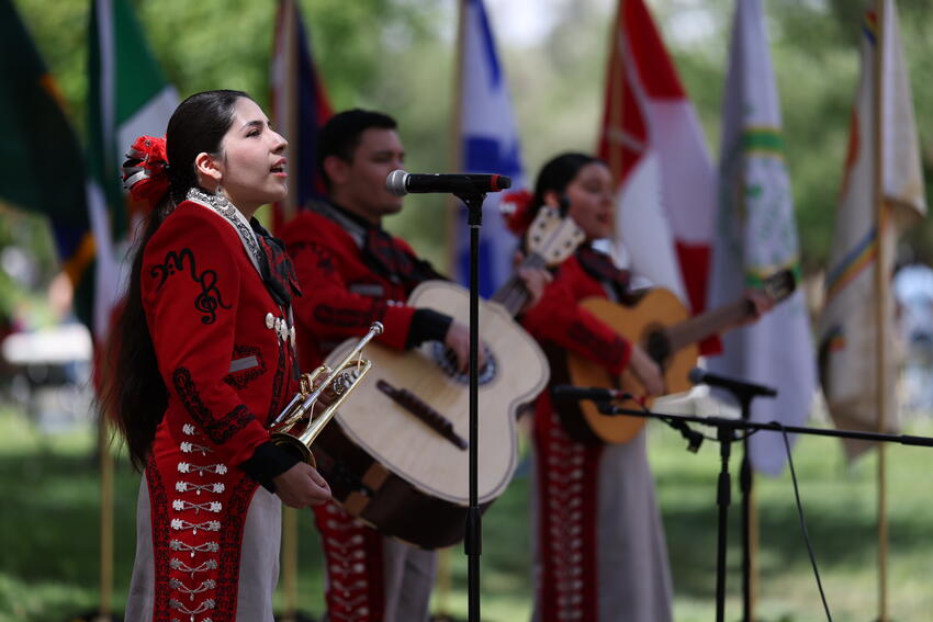 Three mariachi singers performing at Pida Plaza