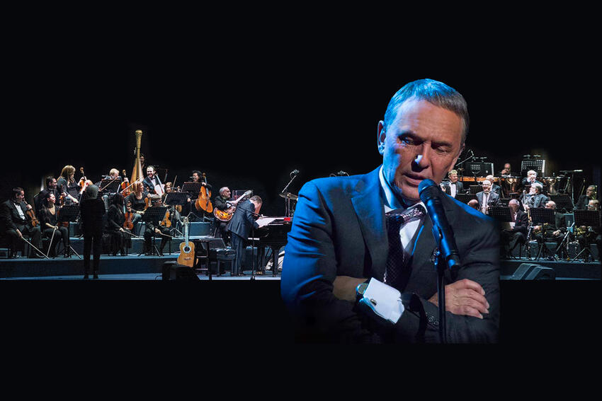 Bob Anderson impersonating Frank Sinatra on stage in front of an orchestra