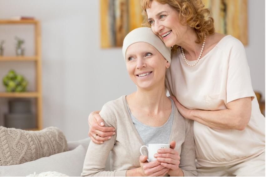 A woman with her arm around another woman