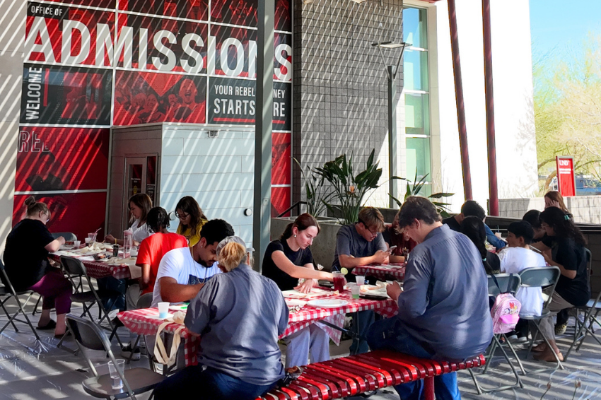 A group of students sitting at picnic tables