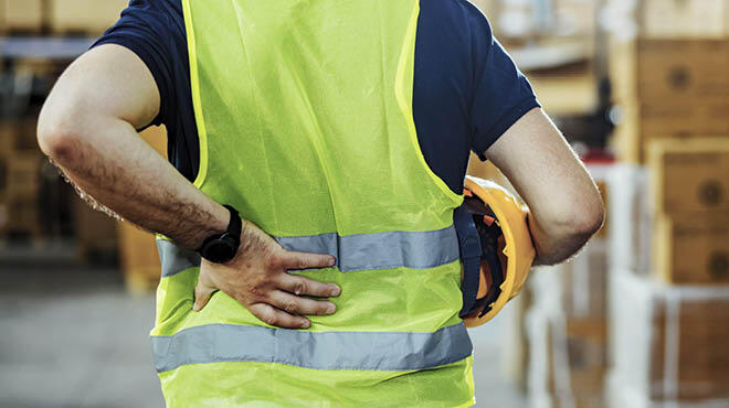 An image of a person holding their lower back