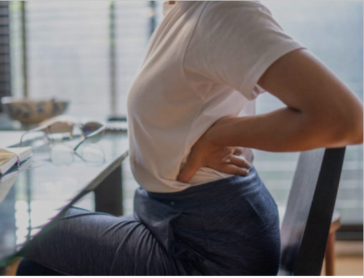 a person stretching at their desk