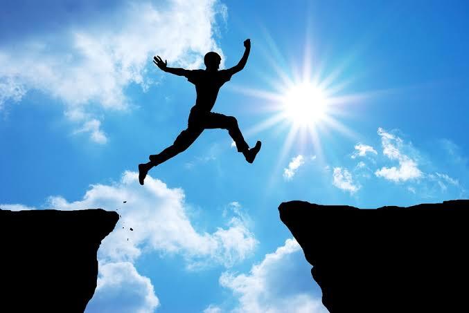 A mean leaping from one edge of a mountain to the other