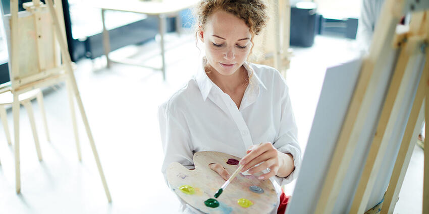 Woman painting on a canvas