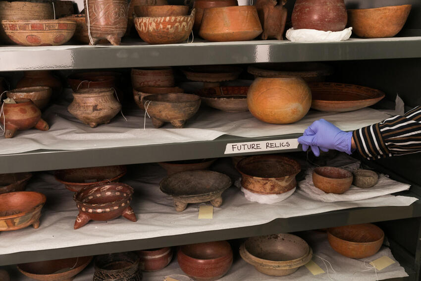 Pottery and relics on a shelf with the label that says Future Relics