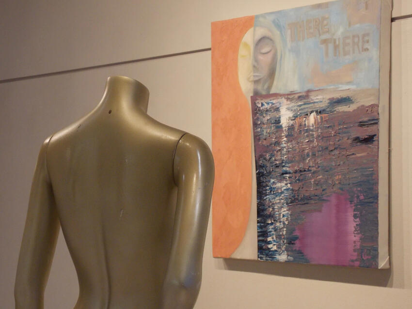 Mannequin facing a painting on the wall