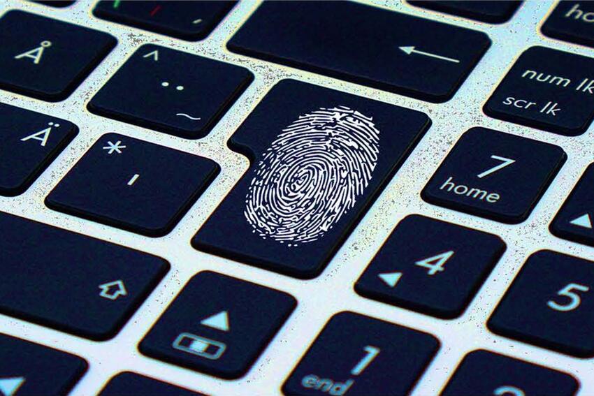 A thumbprint on a keyboard.