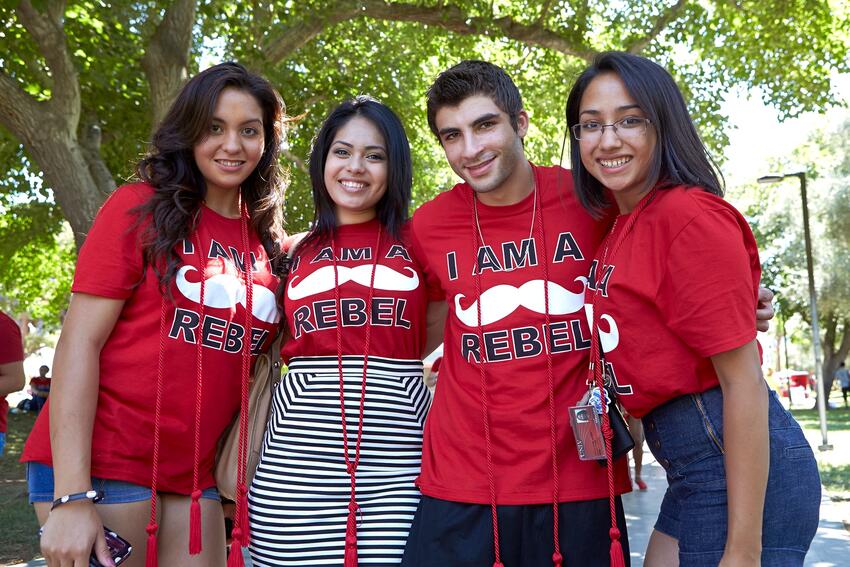 Four students wearing I am a rebel t-shirt