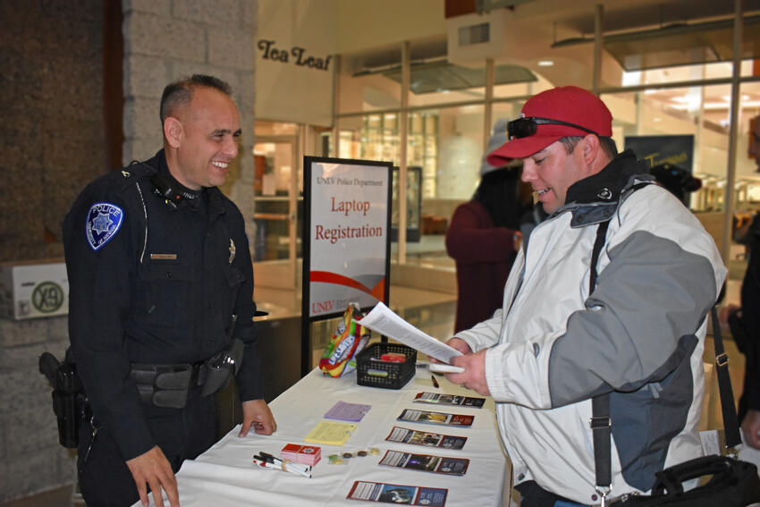 Student and UNLV officer at property registration table