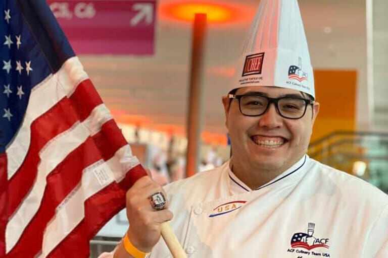 Chef Marc holding the American flag.
