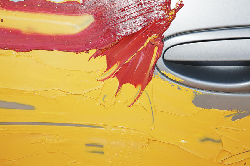 Yellow and red paint on a car door