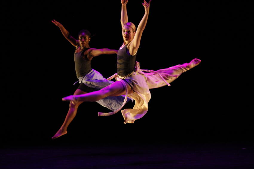 Two dancers perform on stage