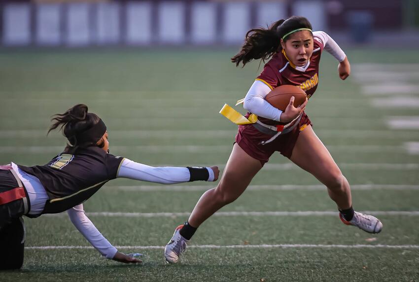 Two women playing flag football