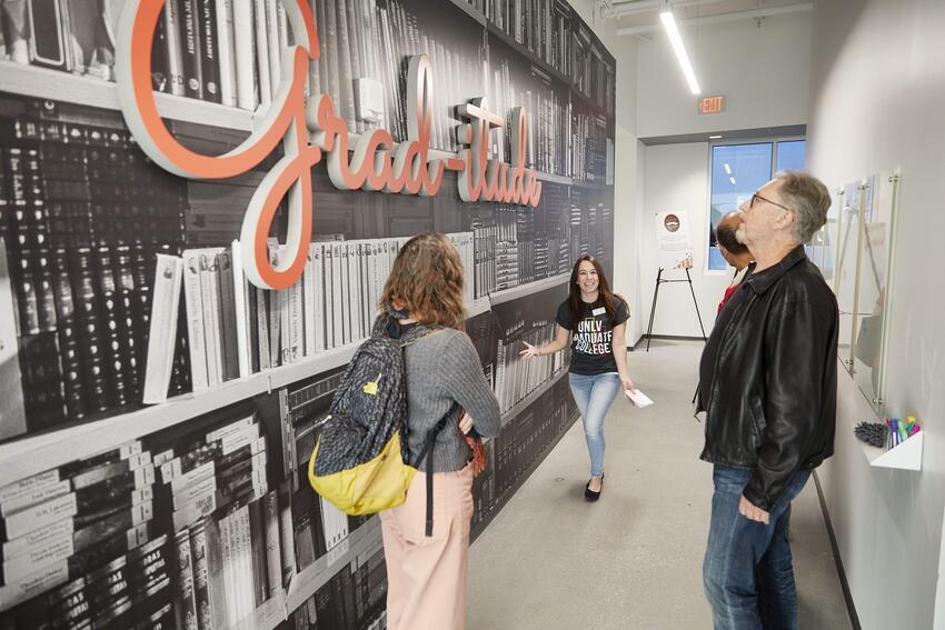 Students looking at a wall mural that says Graditude