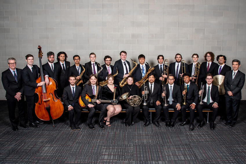 The directors of Jazz Ensemble I, Dave Loeb and Nathan Tanouye, stand on either side of all the young artists in the ensemble in this publicity photo.