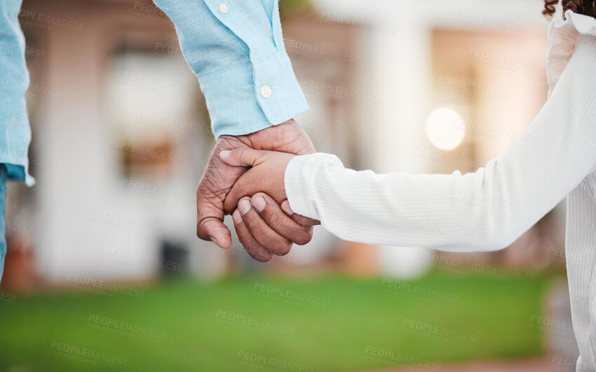 A parent holding a child's hand